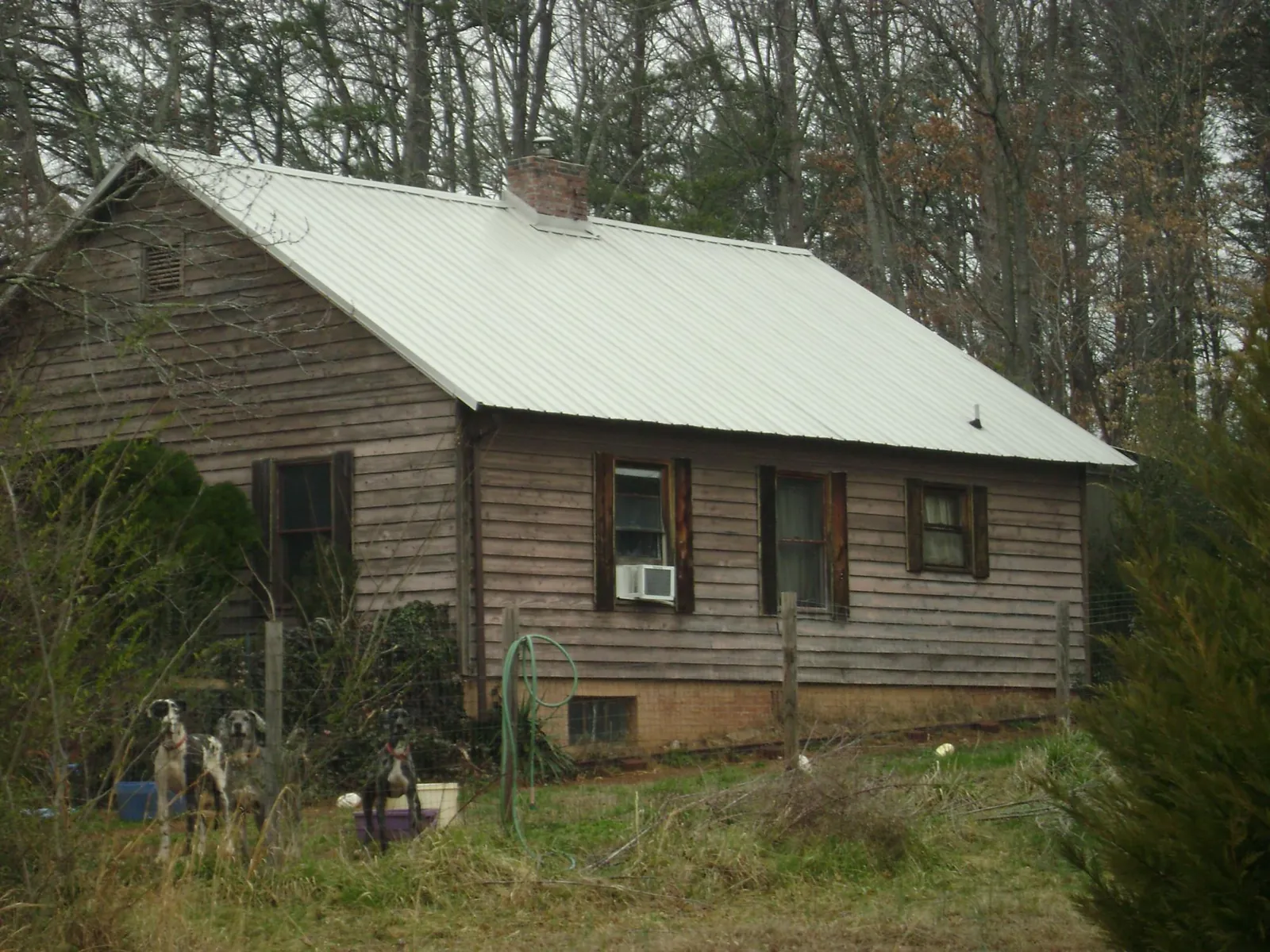 White metal roof on an old wood sided farmhouse, from a Asphalt Shingle Roof Repair job in Takoma Park